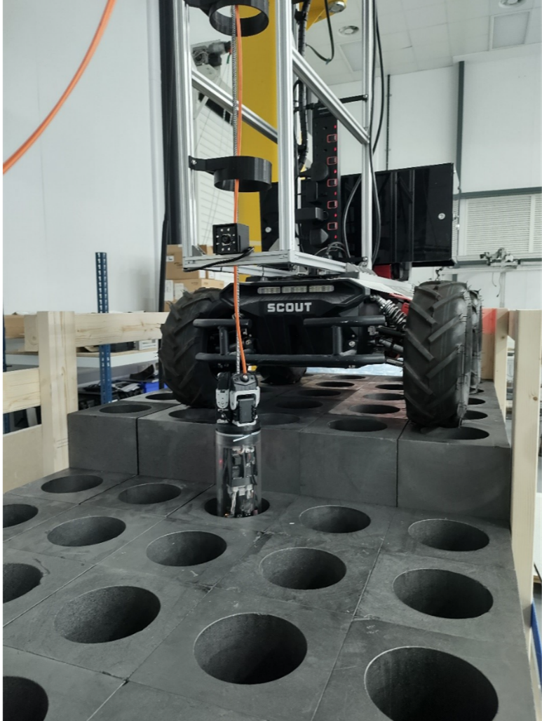 A Robot drops a probe into a graphite core mock up